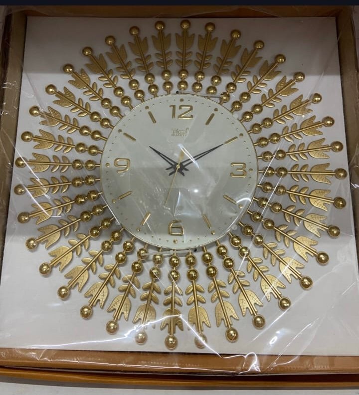 Luxury Gold Sunburst Quartz Wall Clock | Size 18X18 IN | | Inspired by sunbeams and delicate feather motifs | Accented with polished metallic gold beads. |   WITH 1 YEAR WARRANTY |